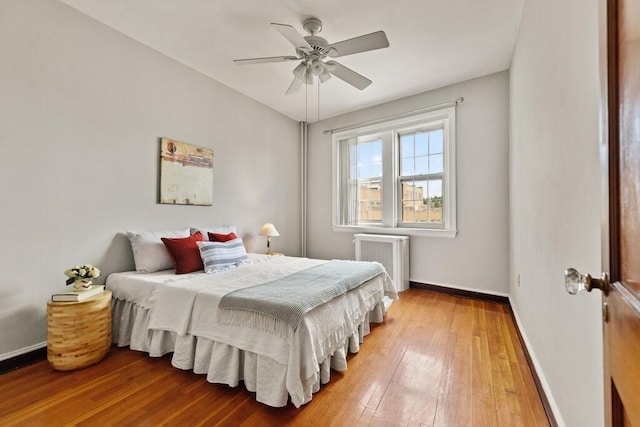 3 Arlington St Unit 31, Cambridge, MA 02140 - bedroom featuring baseboards, light wood-style flooring, ceiling fan, and radiator heating unit