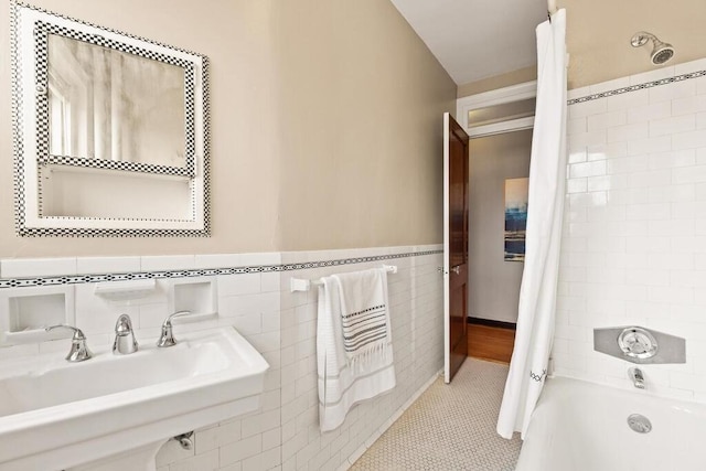3 Arlington St Unit 31, Cambridge, MA 02140 - full bathroom with shower / tub combo with curtain, tile walls, a sink, tile patterned flooring, and a wainscoted wall