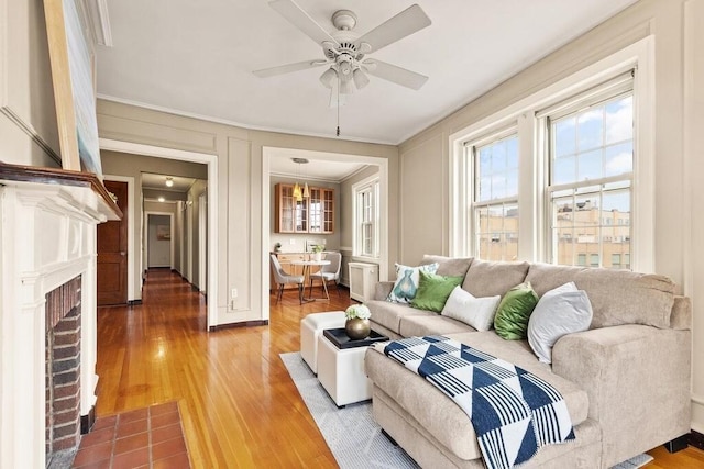 3 Arlington St Unit 31, Cambridge, MA 02140 - living room featuring ornamental molding, light wood-style floors, a ceiling fan, and a fireplace