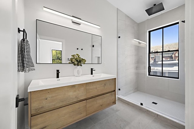 bathroom with vanity and a tile shower