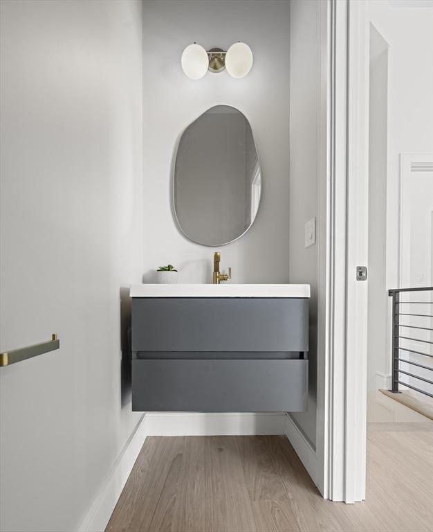 bathroom with vanity and wood-type flooring