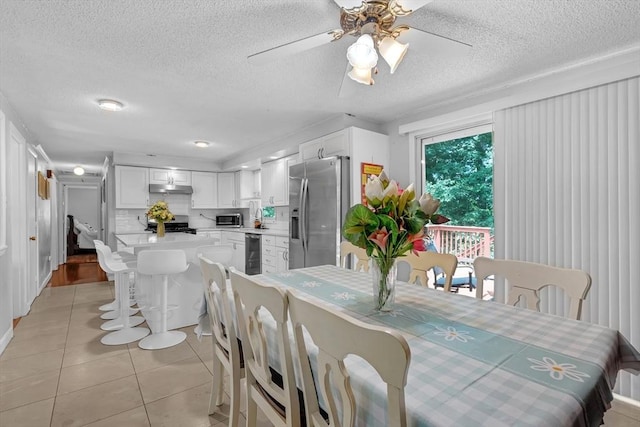 163 Lockland Ave, Framingham, MA 01701 - dining space featuring beverage cooler, a textured ceiling, light tile patterned floors, and a ceiling fan