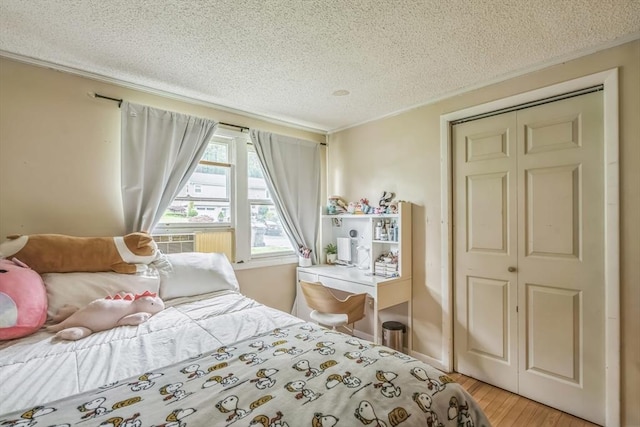163 Lockland Ave, Framingham, MA 01701 - bedroom with a textured ceiling, light wood finished floors, ornamental molding, and cooling unit