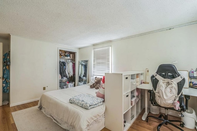163 Lockland Ave, Framingham, MA 01701 - bedroom with a textured ceiling, wood finished floors, and a closet