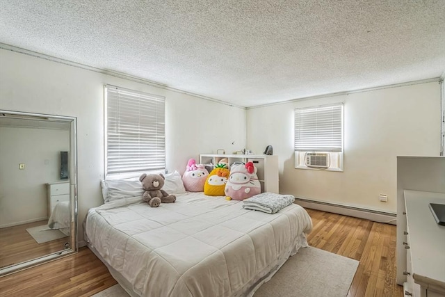 163 Lockland Ave, Framingham, MA 01701 - bedroom with baseboard heating, wood finished floors, and a textured ceiling