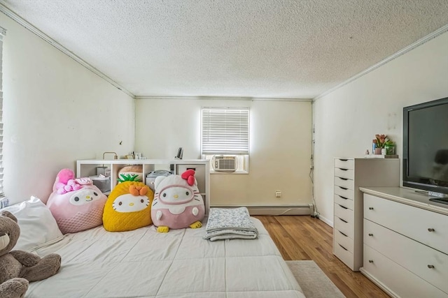 163 Lockland Ave, Framingham, MA 01701 - bedroom with ornamental molding, wood finished floors, a textured ceiling, baseboard heating, and cooling unit