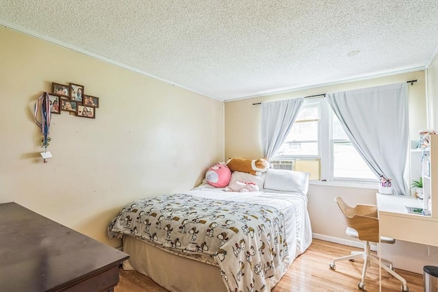 163 Lockland Ave, Framingham, MA 01701 - bedroom featuring a textured ceiling, ornamental molding, wood finished floors, and cooling unit