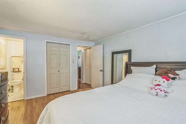 163 Lockland Ave, Framingham, MA 01701 - bedroom with crown molding, light wood-style flooring, a textured ceiling, ensuite bathroom, and baseboards