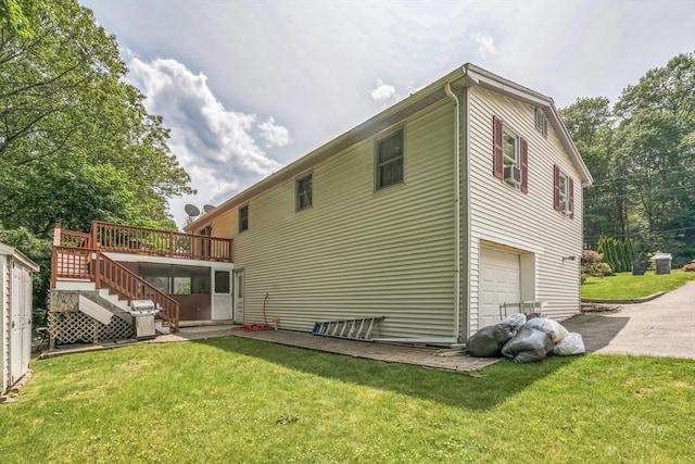 163 Lockland Ave, Framingham, MA 01701 - back of property with stairway, a deck, a garage, and a yard