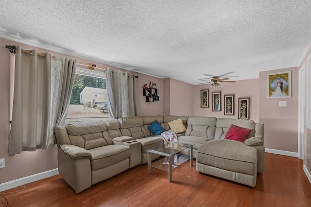 163 Lockland Ave, Framingham, MA 01701 - living area with a textured ceiling, baseboards, wood finished floors, a ceiling fan, and ornamental molding