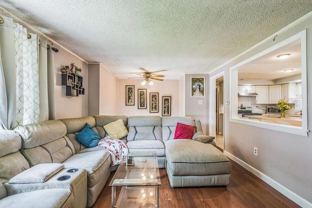 163 Lockland Ave, Framingham, MA 01701 - living room featuring a textured ceiling, dark wood-style flooring, a ceiling fan, baseboards, and crown molding