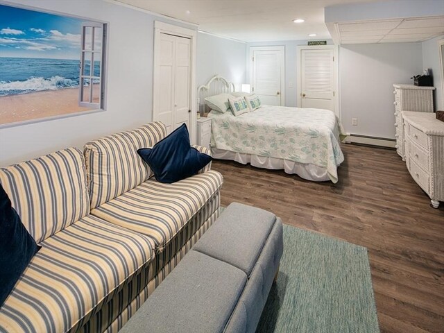 bedroom with visible vents, baseboard heating, dark wood finished floors, a closet, and recessed lighting
