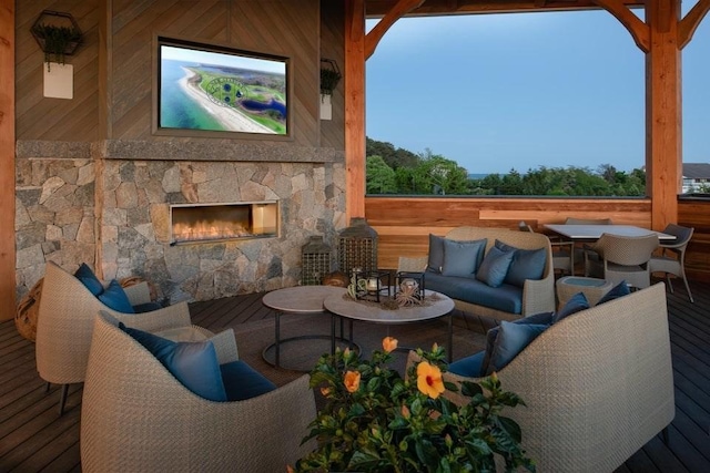 view of patio featuring an outdoor living space with a fireplace and a wooden deck