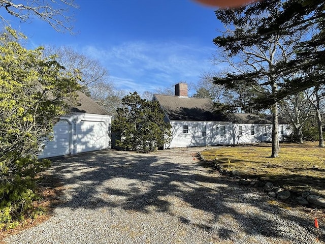 exterior space featuring a chimney and an outdoor structure