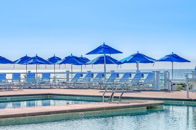 view of pool featuring a water view
