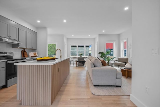 30A Emerald Rd Unit A, Nahant, MA 01908 - kitchen with stainless steel electric range, gray cabinetry, under cabinet range hood, open floor plan, and recessed lighting