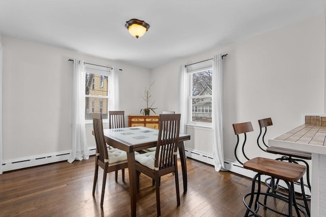 dining area featuring dark wood-type flooring and baseboard heating