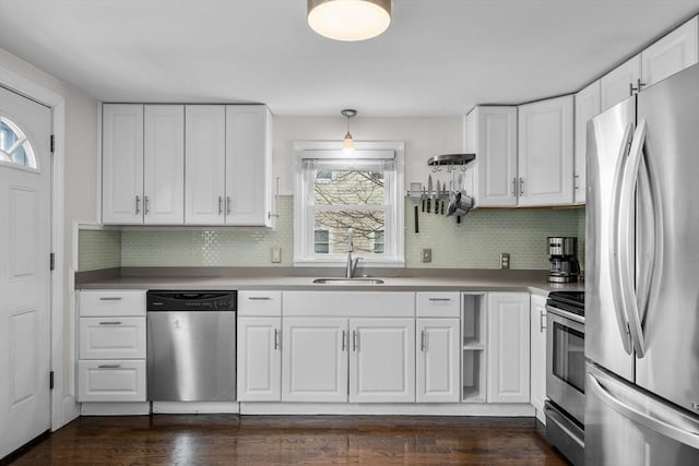 kitchen with plenty of natural light, a sink, white cabinetry, and stainless steel appliances