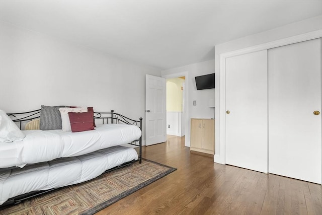 bedroom featuring a closet and wood finished floors
