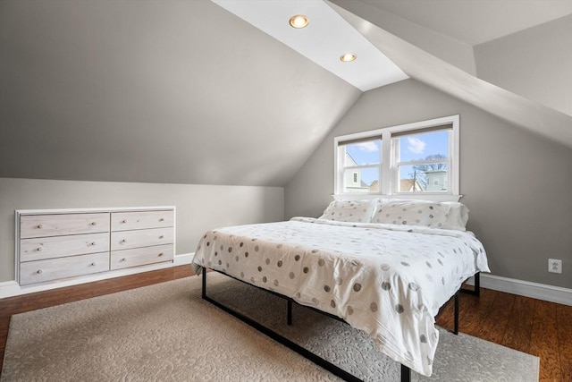 bedroom featuring baseboards, vaulted ceiling, recessed lighting, and wood finished floors