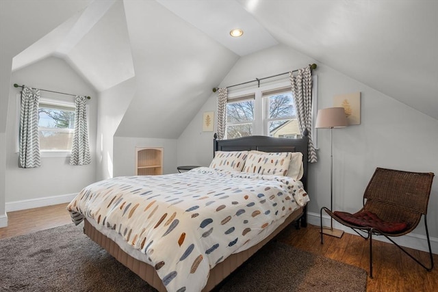 bedroom with multiple windows, wood finished floors, and lofted ceiling