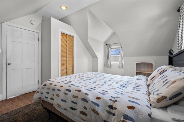 bedroom featuring recessed lighting, wood finished floors, lofted ceiling, and a closet