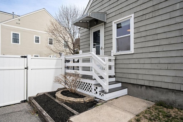 view of side of home with a gate and fence