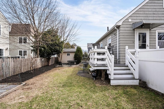 view of yard with a wooden deck and fence