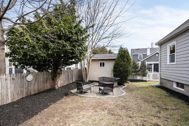 view of yard featuring an outdoor living space, a fenced backyard, and a patio area