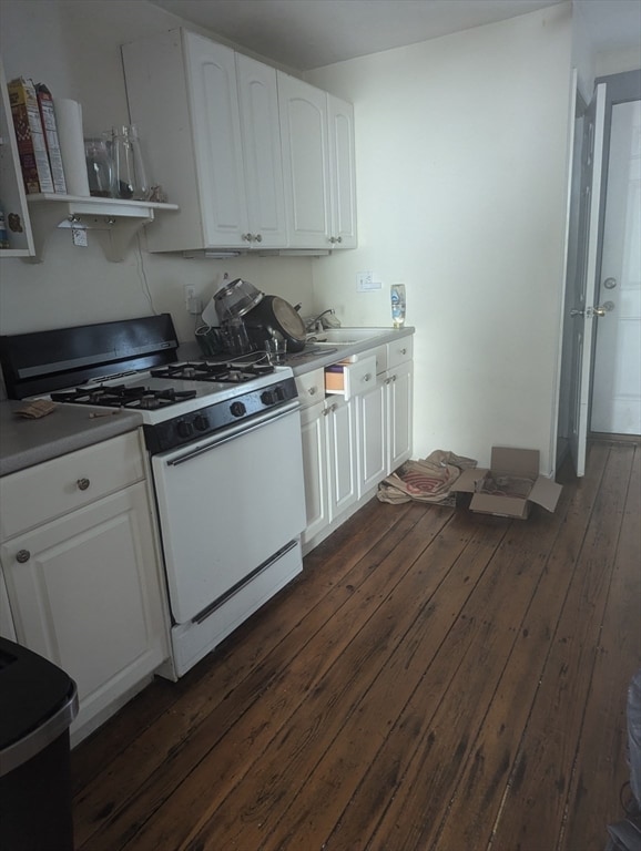 kitchen with white cabinetry, gas range gas stove, sink, and dark hardwood / wood-style flooring