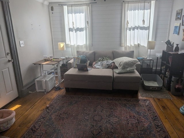 living room with dark wood-type flooring and wood walls