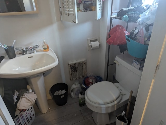 bathroom with toilet and wood-type flooring