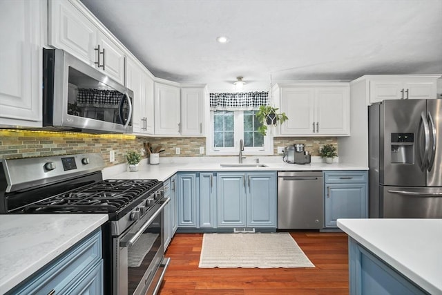 12 Wilson St, Randolph, MA 02368 - kitchen with appliances with stainless steel finishes, white cabinetry, backsplash, light countertops, and recessed lighting