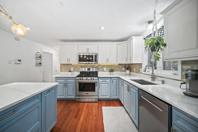 12 Wilson St, Randolph, MA 02368 - kitchen featuring appliances with stainless steel finishes, blue cabinets, tasteful backsplash, white cabinetry, and dark wood-type flooring