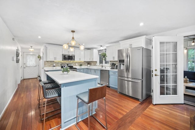 12 Wilson St, Randolph, MA 02368 - kitchen featuring stainless steel appliances, wood-type flooring, plenty of natural light, light countertops, and recessed lighting