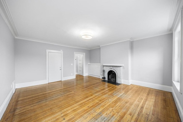 100 Charles St Unit 5, Boston, MA 02114 - unfurnished living room with light wood-type flooring, ornamental molding, and a fireplace with flush hearth