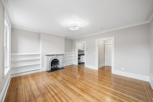 100 Charles St Unit 5, Boston, MA 02114 - unfurnished living room featuring crown molding, a fireplace with flush hearth, wood finished floors, and built in features