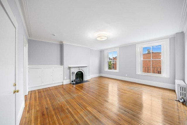 100 Charles St Unit 5, Boston, MA 02114 - unfurnished living room with radiator heating unit, wood finished floors, a fireplace with flush hearth, and ornamental molding