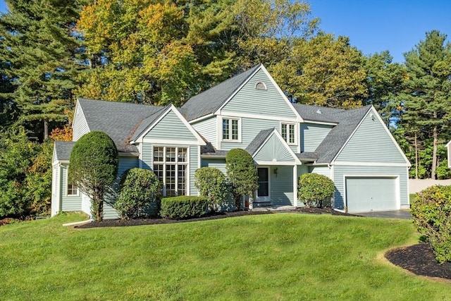 view of front of home with a garage and a front lawn