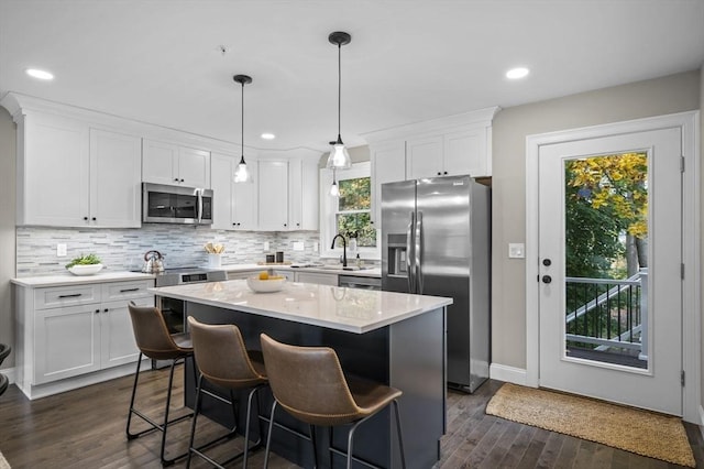 9 Acton Rd Unit 16, Chelmsford, MA 01824 - kitchen featuring appliances with stainless steel finishes, dark wood-style floors, decorative backsplash, white cabinets, and recessed lighting