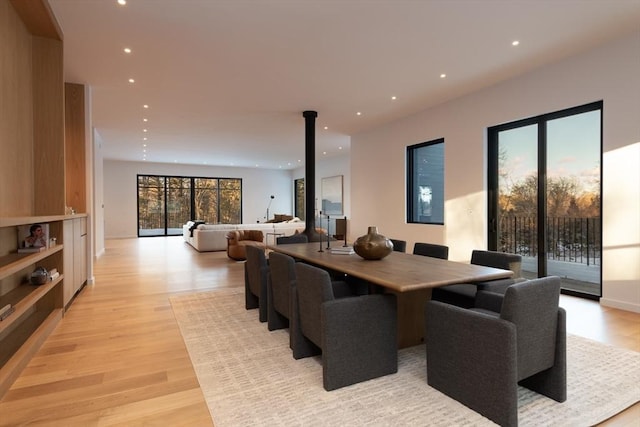 dining room with recessed lighting and light wood-style floors