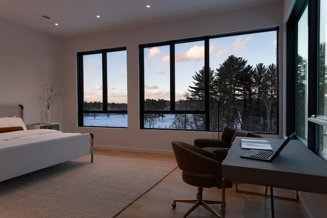 bedroom with recessed lighting, baseboards, and wood finished floors