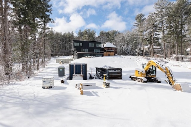 view of snow covered rear of property