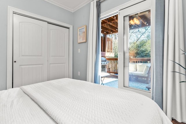 bedroom with access to outside, a closet, and crown molding