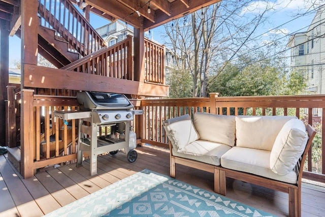 wooden deck with grilling area and an outdoor living space