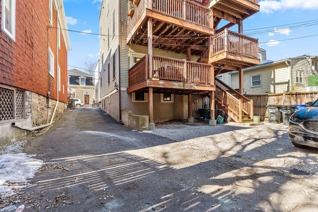 back of property with stairs and brick siding