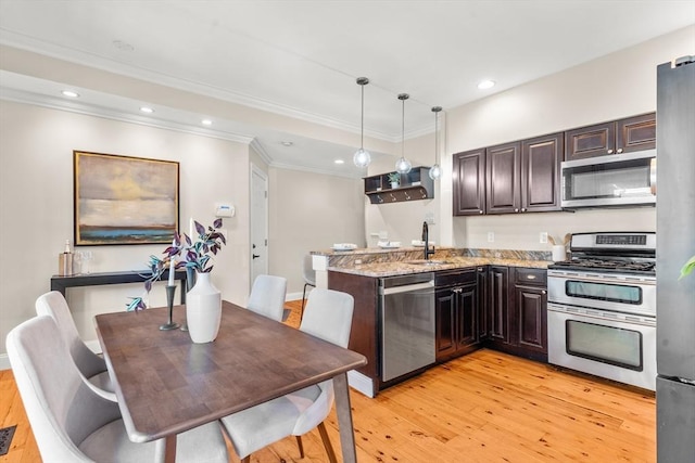 kitchen featuring light wood finished floors, recessed lighting, appliances with stainless steel finishes, dark brown cabinets, and a peninsula