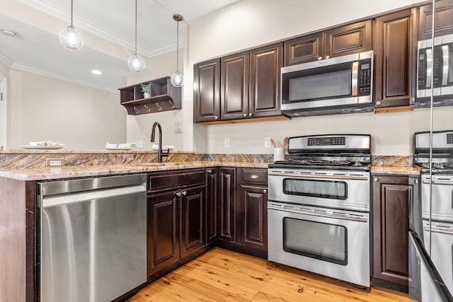 kitchen with stainless steel appliances, a sink, dark brown cabinets, light wood-type flooring, and crown molding