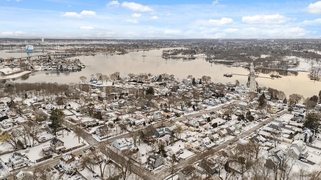 snowy aerial view with a water view