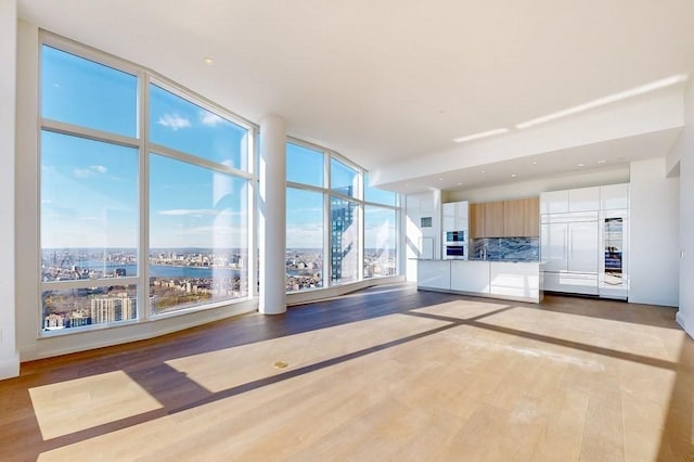 unfurnished living room featuring hardwood / wood-style flooring